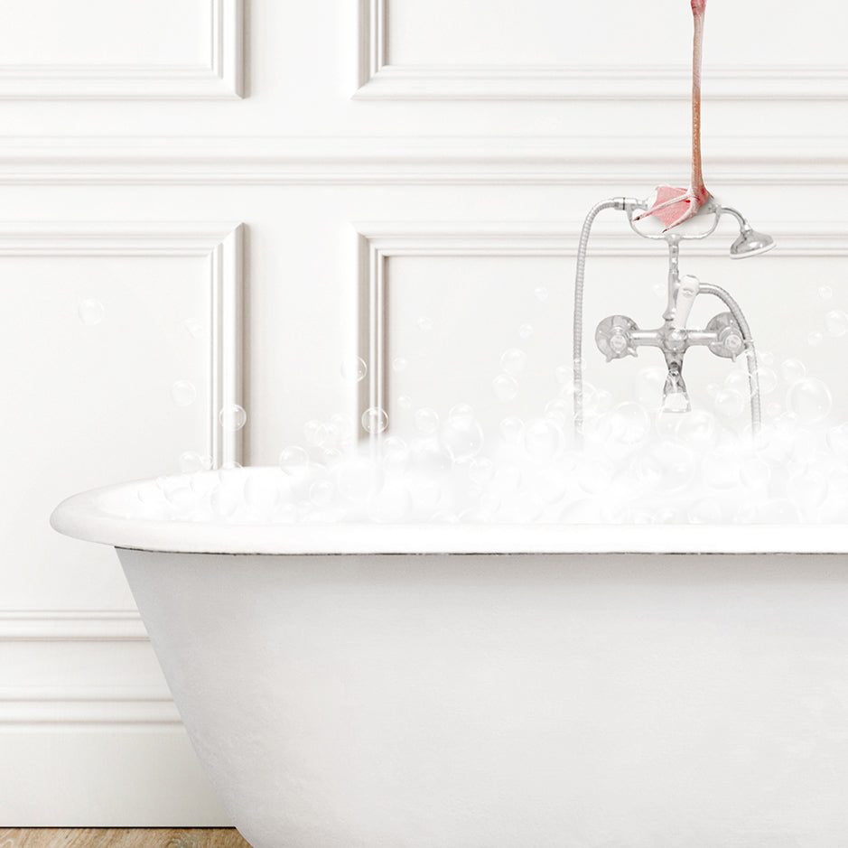 a white bath tub filled with foam and a pink flamingo