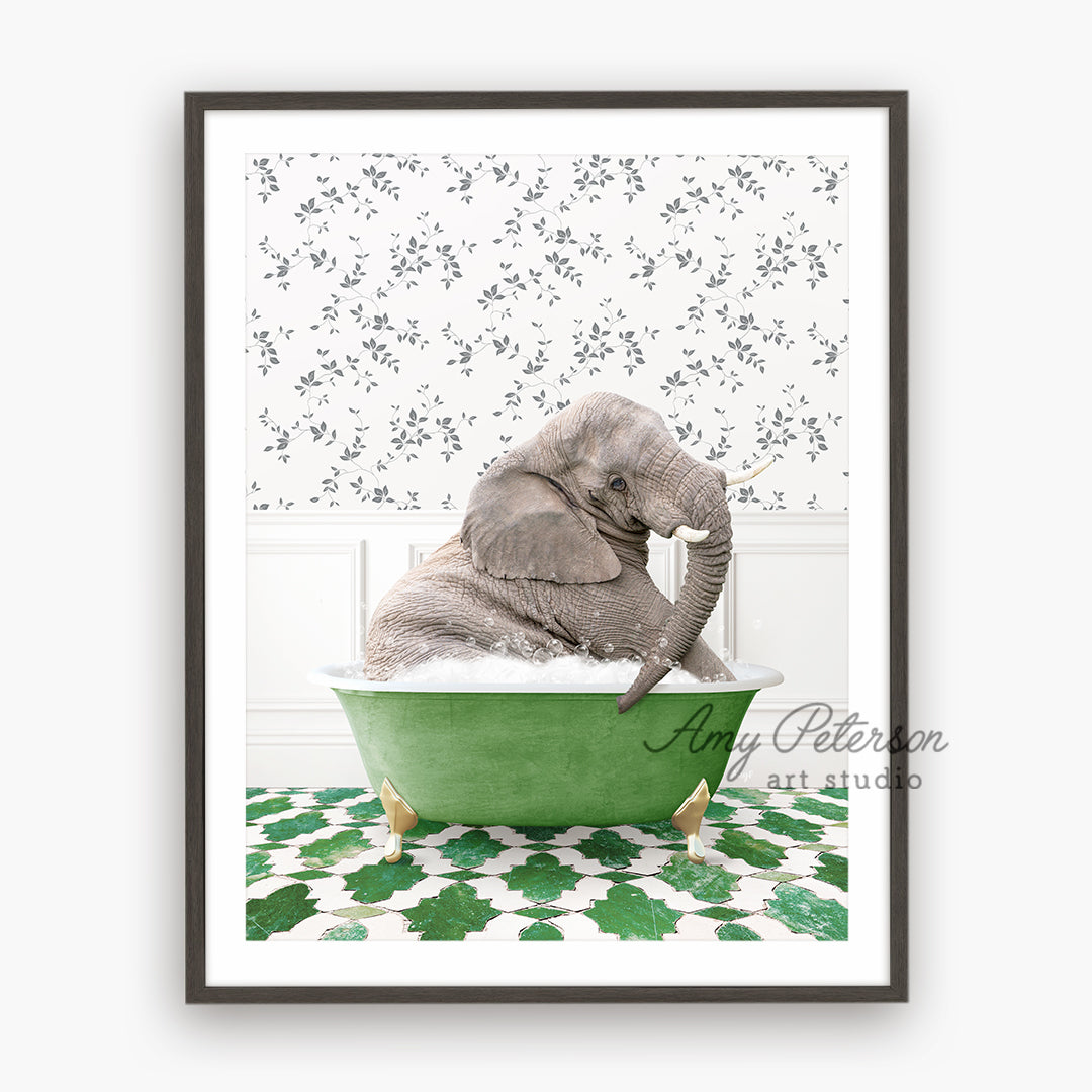 a baby elephant sitting in a green bath tub