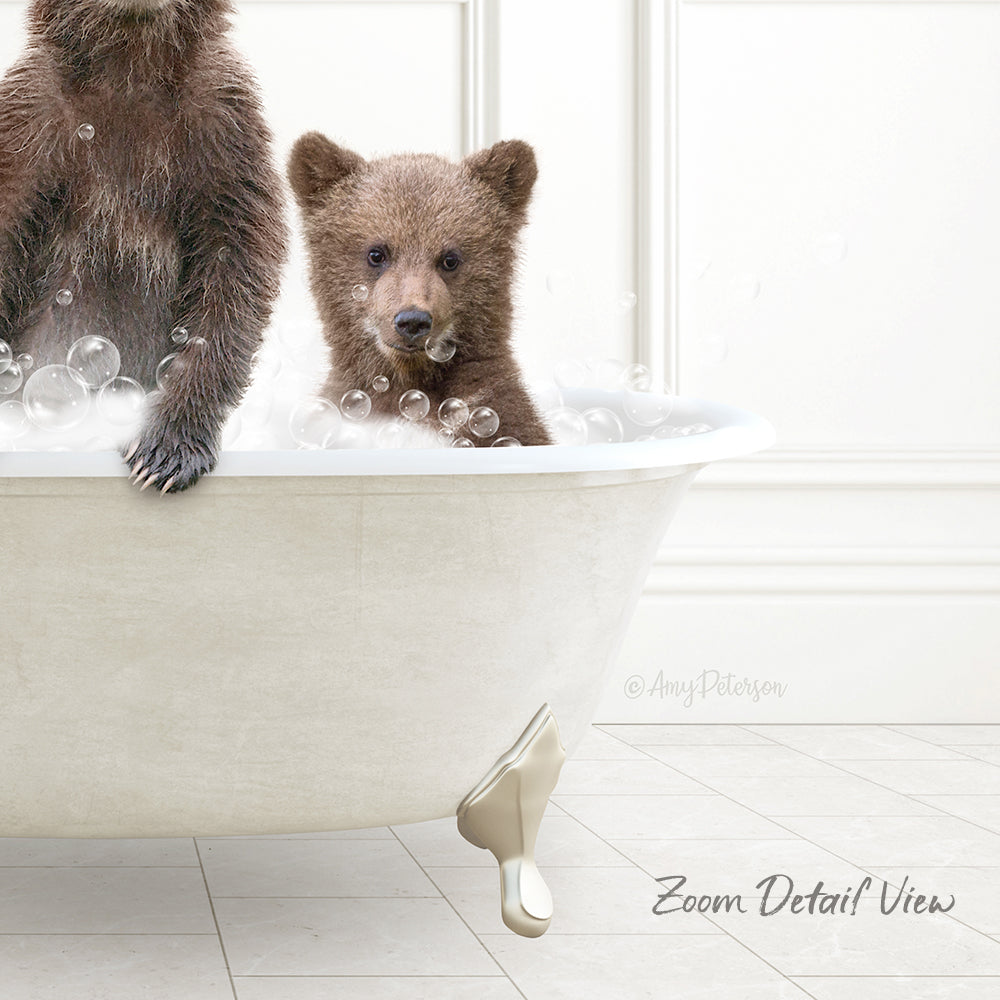 A baby bear sitting in a bathtub filled with bubbles, with another bear standing next to it.