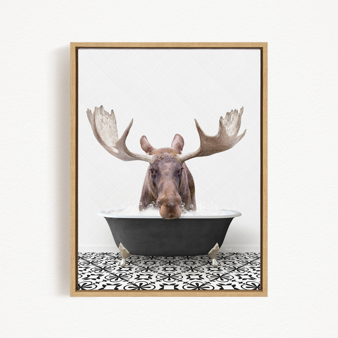 A moose with large antlers is sitting in a bathtub filled with water, creating a whimsical and humorous scene.
