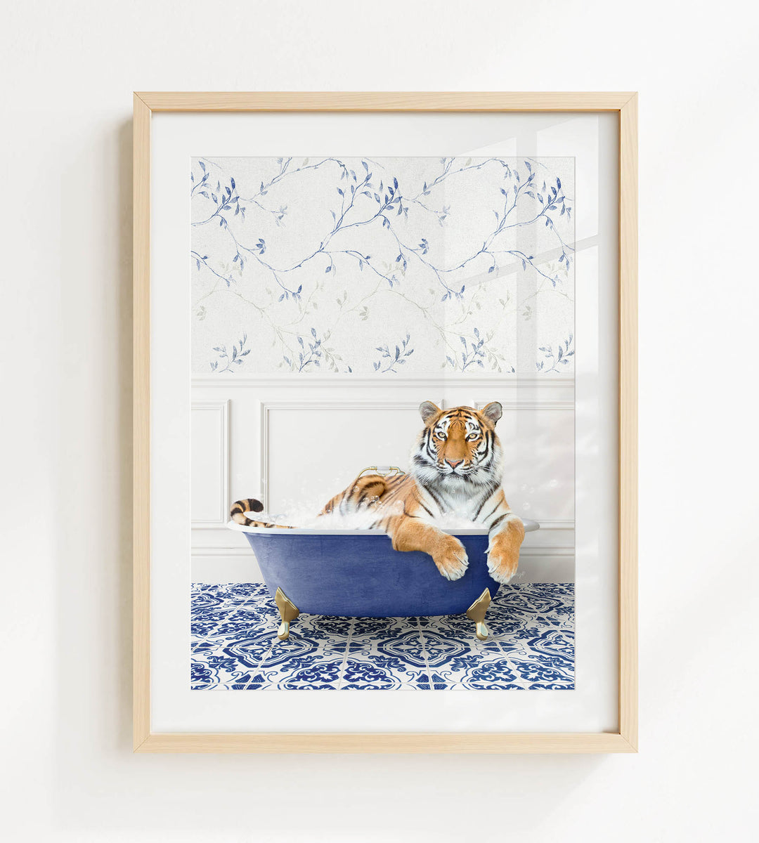 A tiger is sitting in a blue bathtub, surrounded by a patterned blue and white tile floor.