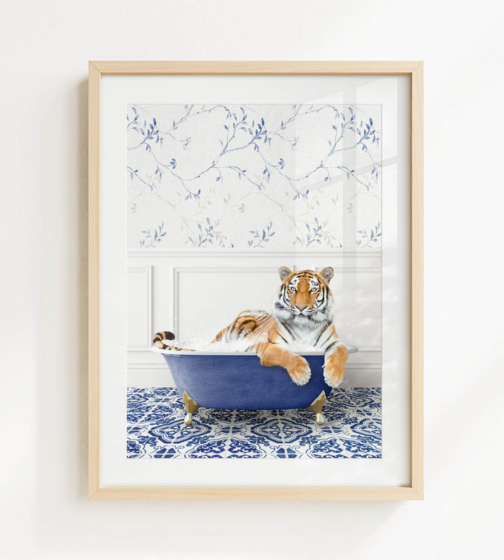 A tiger is sitting in a blue bathtub, surrounded by a patterned blue and white tile floor.