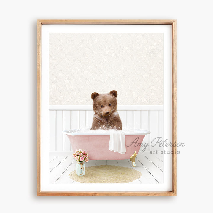 a brown teddy bear sitting in a pink bath tub