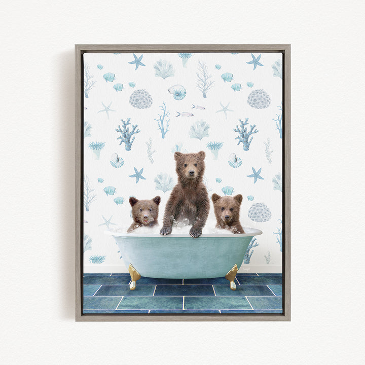 A framed image depicting three bears sitting in a bathtub filled with water, surrounded by a blue and white ocean-themed wallpaper.