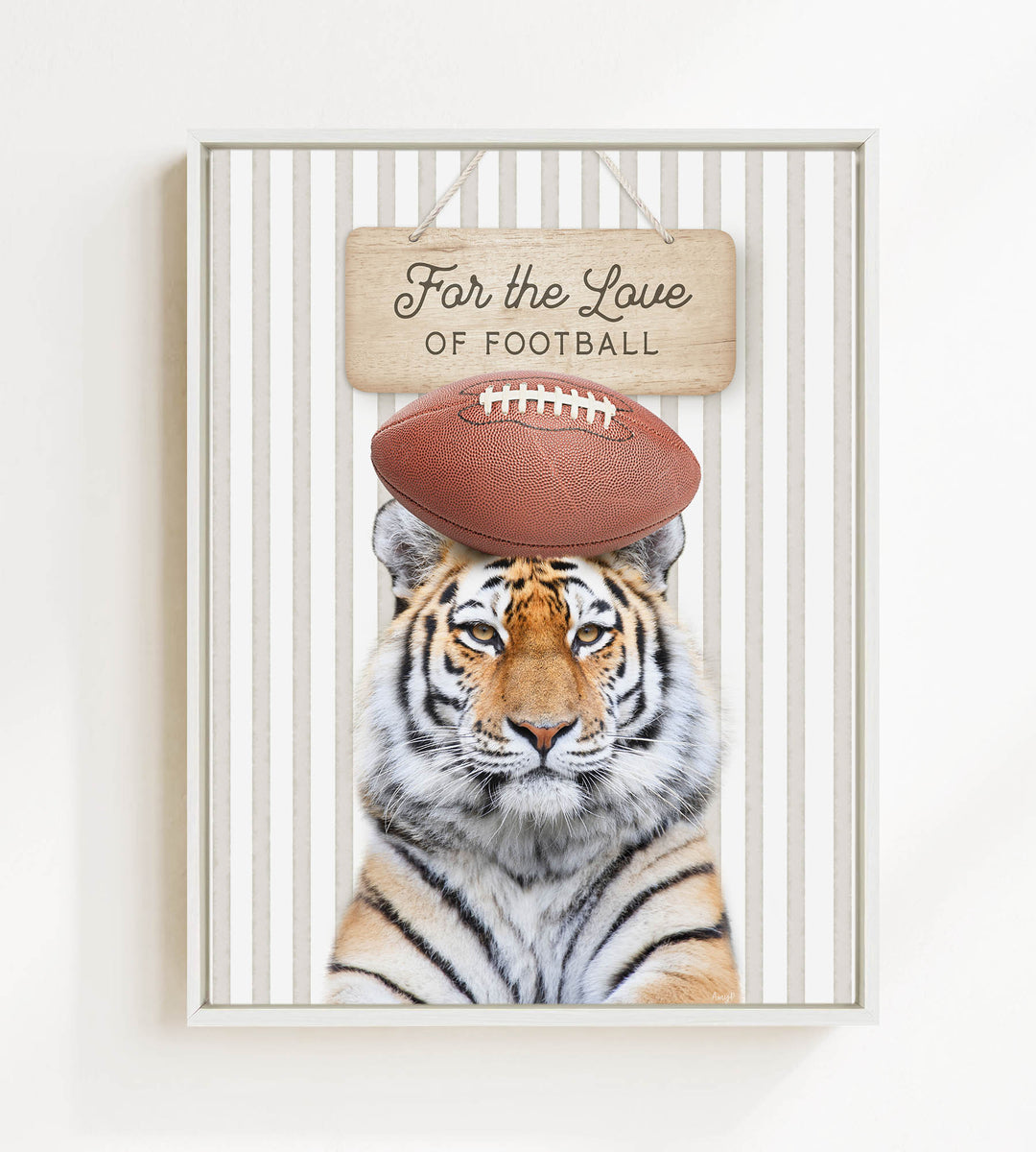 A tiger wearing a football helmet and standing in front of a sign that says "For the Love of Football".