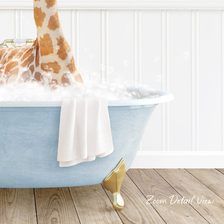 A giraffe standing in a blue bathtub filled with bubbles, with a towel and gold bathtub leg visible.