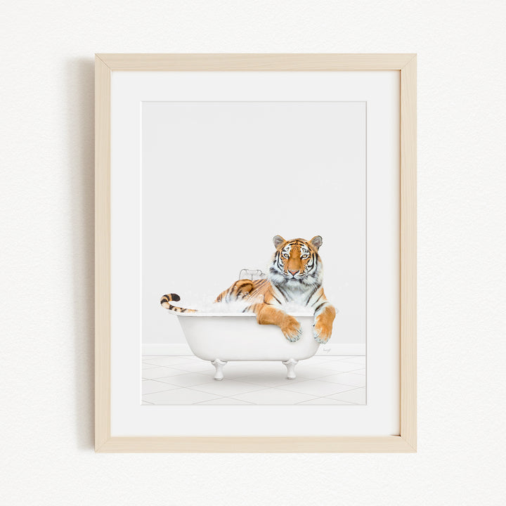 A tiger is sitting in a white bathtub filled with water, appearing relaxed and enjoying the bath.