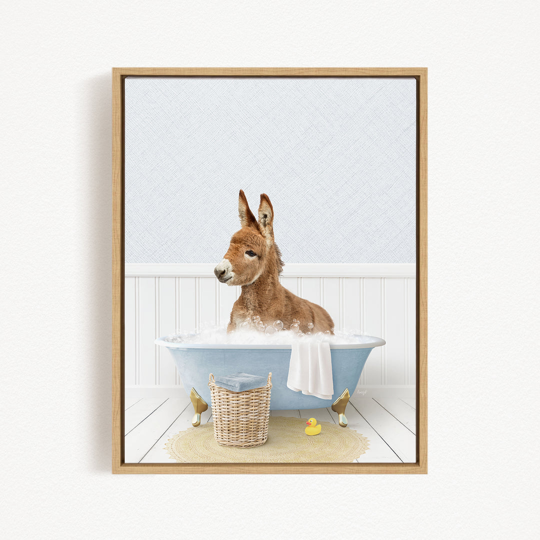 A donkey is sitting in a blue bathtub filled with water, surrounded by rubber ducks.
