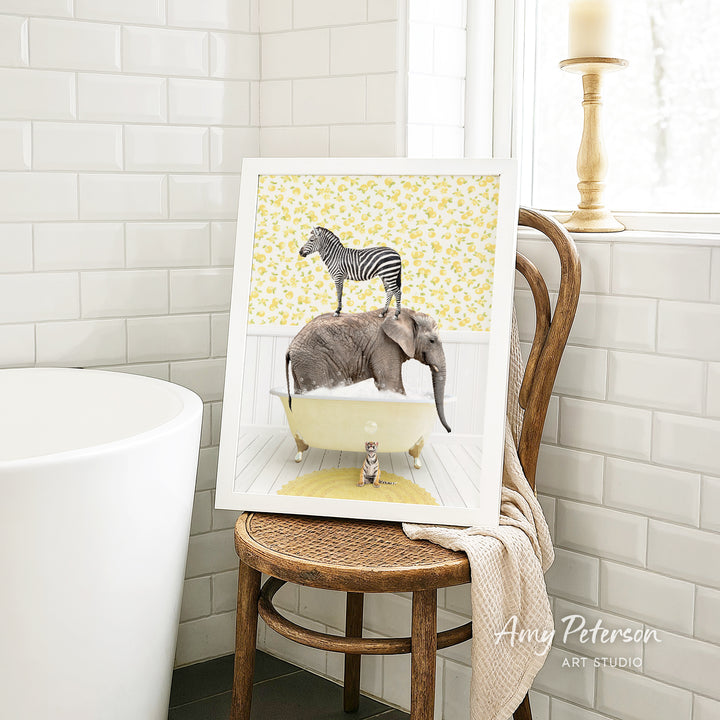 A framed image depicting a zebra standing on an elephant in a bathtub, with a cat sitting on the elephant's back.