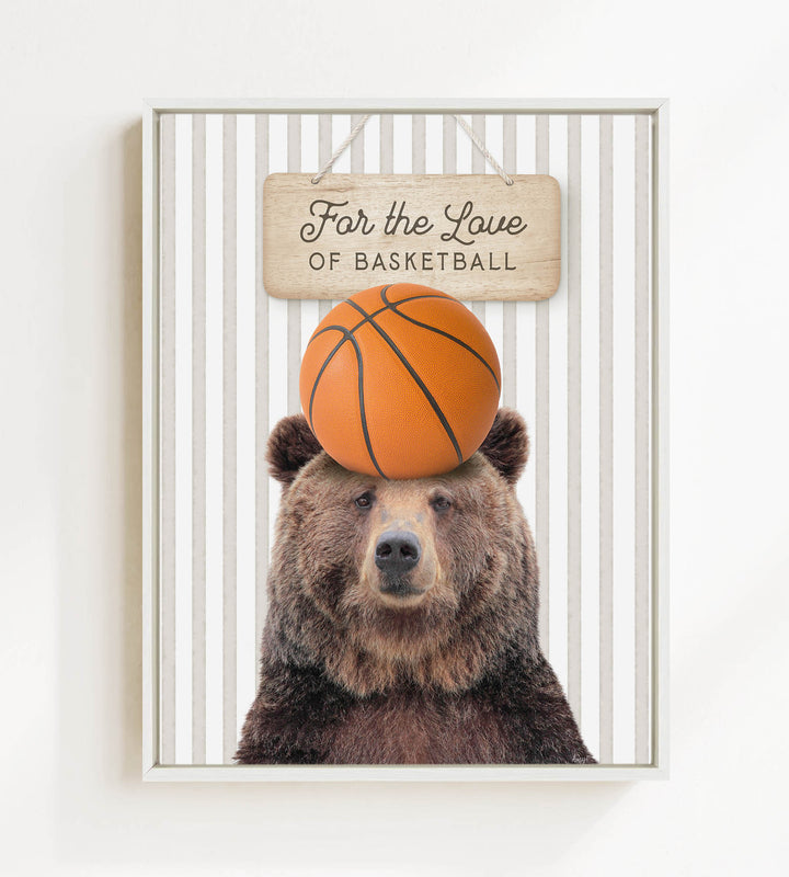 A brown bear holding a basketball on its head, with a sign above that says "For the Love of Basketball".