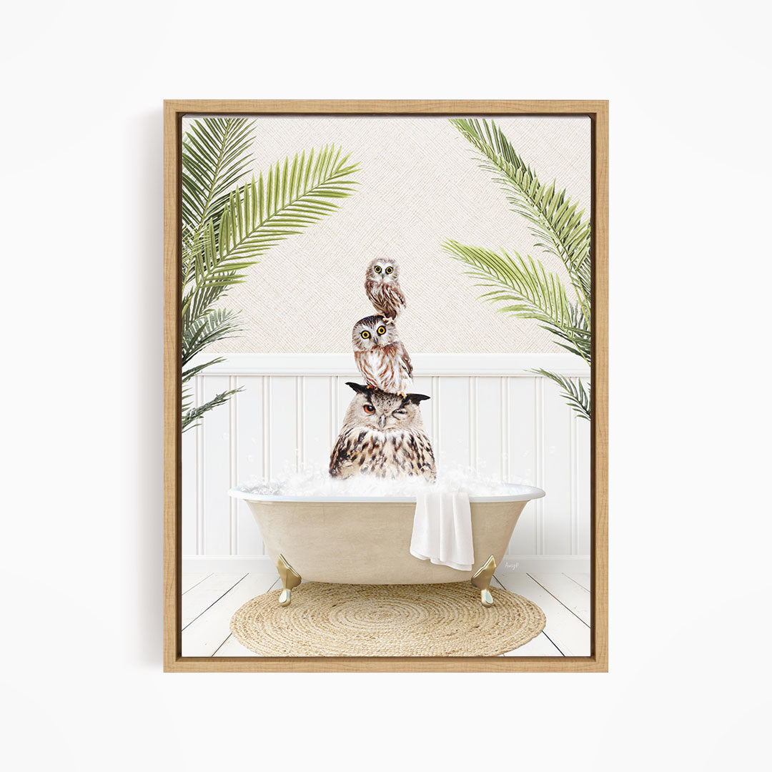 A framed image depicting a group of owls sitting in a bathtub, surrounded by palm leaves.