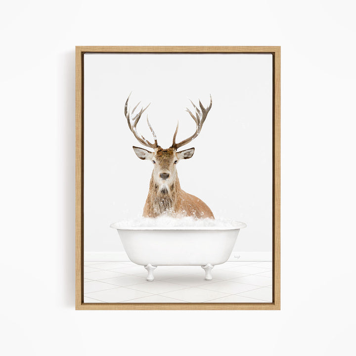 A deer with large antlers is sitting in a white bathtub filled with bubbles, creating a whimsical and humorous scene.