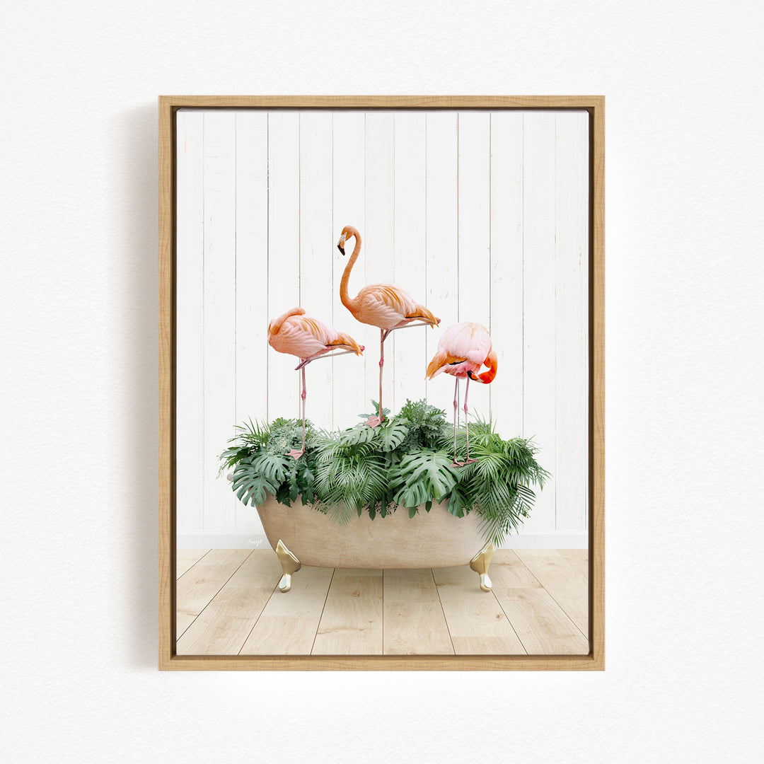 A framed image depicting three flamingos standing in a bathtub filled with green plants.