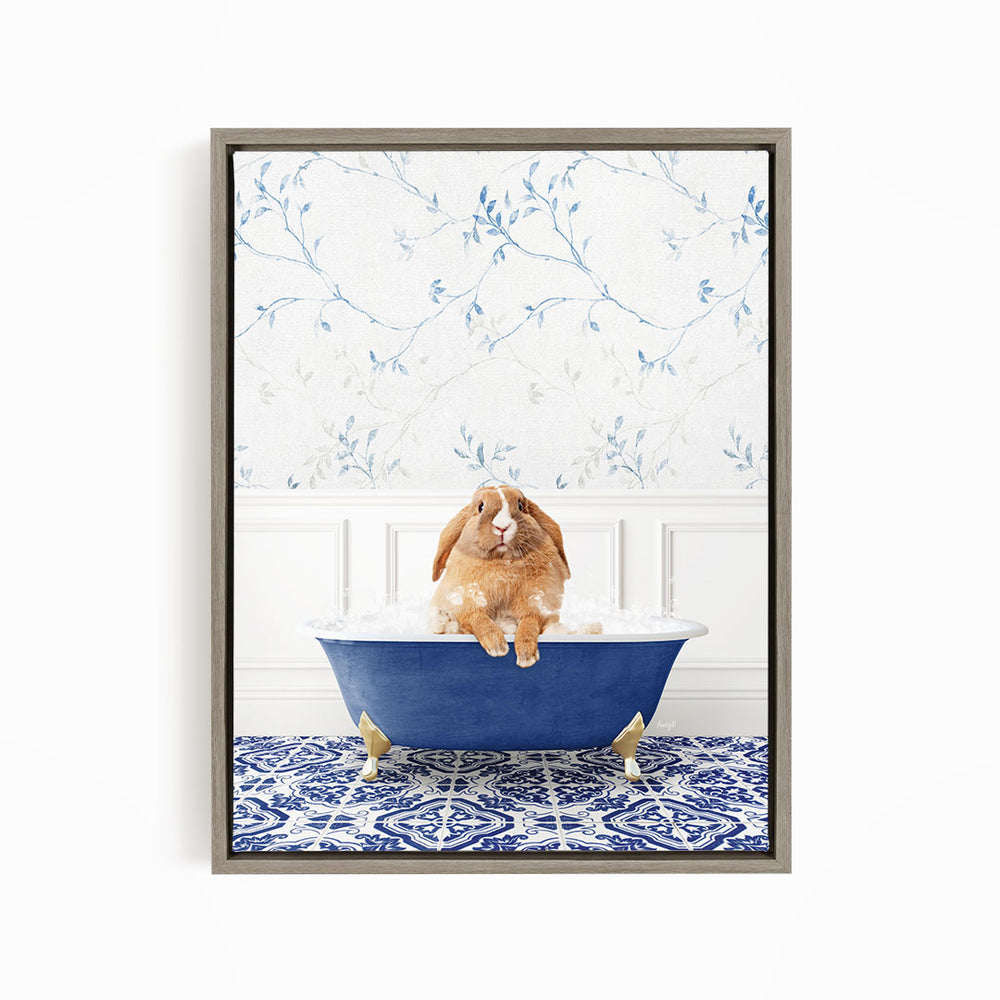 A brown rabbit sitting in a blue bathtub filled with water, surrounded by a blue and white patterned rug on the floor.