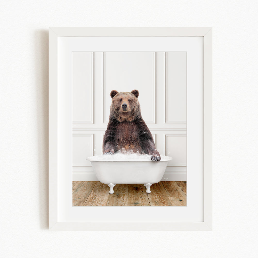 A brown bear sitting in a white bathtub filled with water, appearing to enjoy the bath.
