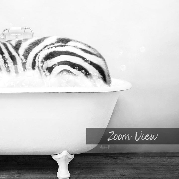 A zebra lying in a bathtub filled with bubbles, as captured in a black and white photograph.