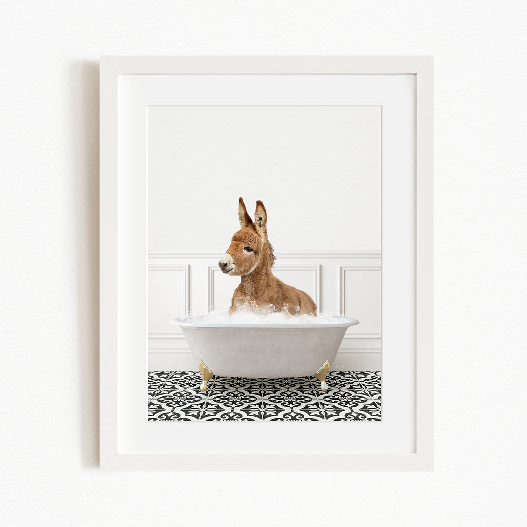 A donkey is sitting in a white bathtub filled with bubbles, creating a whimsical and playful scene.