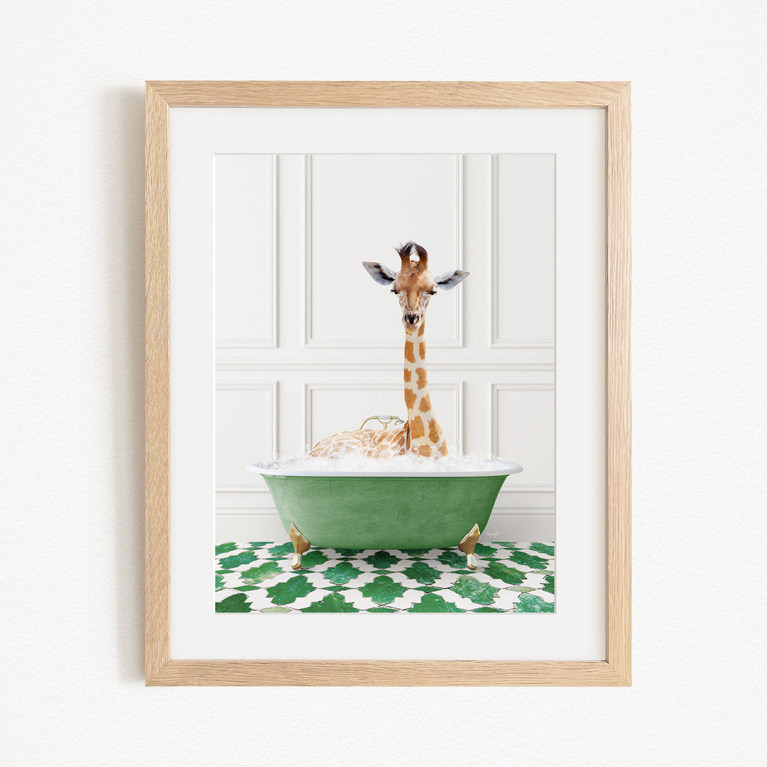 A giraffe sitting in a green bathtub filled with bubbles, surrounded by a green and white patterned rug.