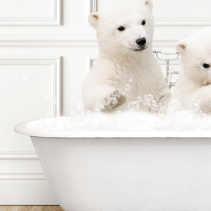 two white polar bears sitting in a bathtub