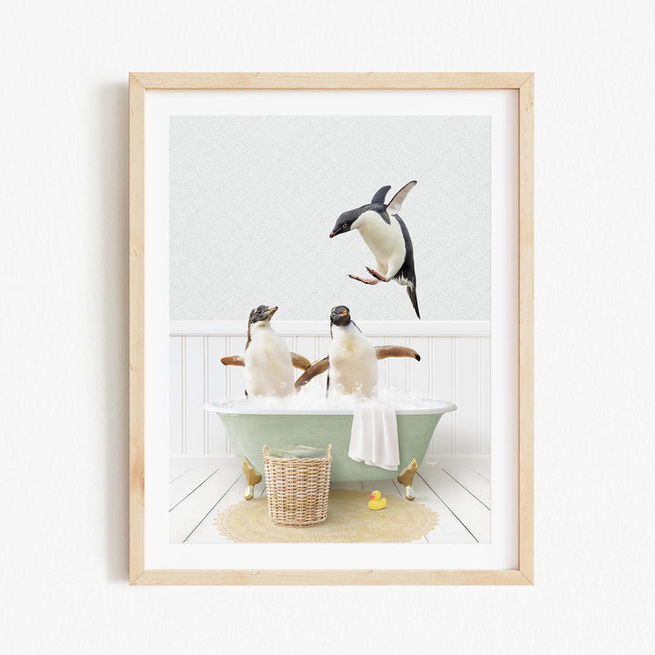 A framed image depicting two penguins sitting in a green bathtub, with one penguin flying towards the other.