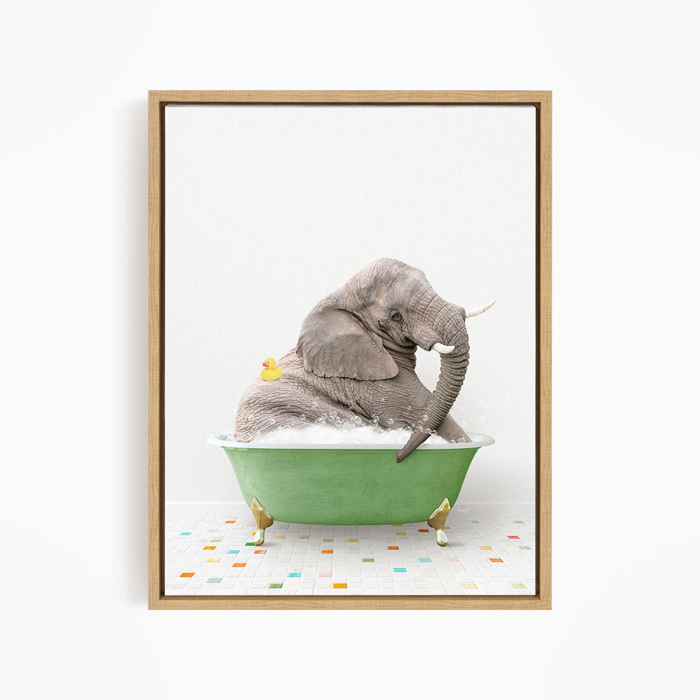 A gray elephant is sitting in a green bathtub, with a yellow duck perched on its back.