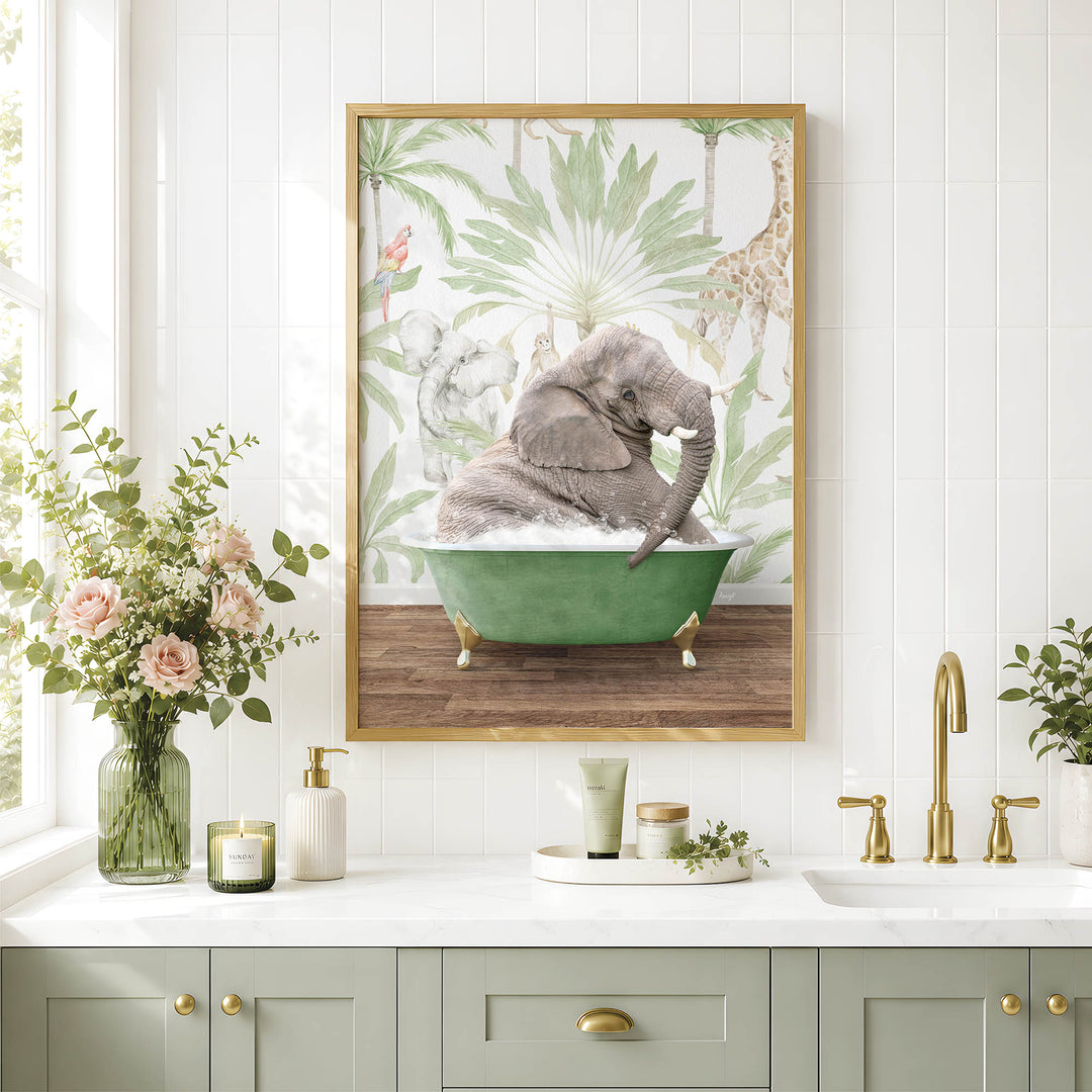 A framed image of a baby elephant sitting in a green bathtub, surrounded by tropical foliage, is displayed on a white wall above a bathroom counter with various toiletries and decor.