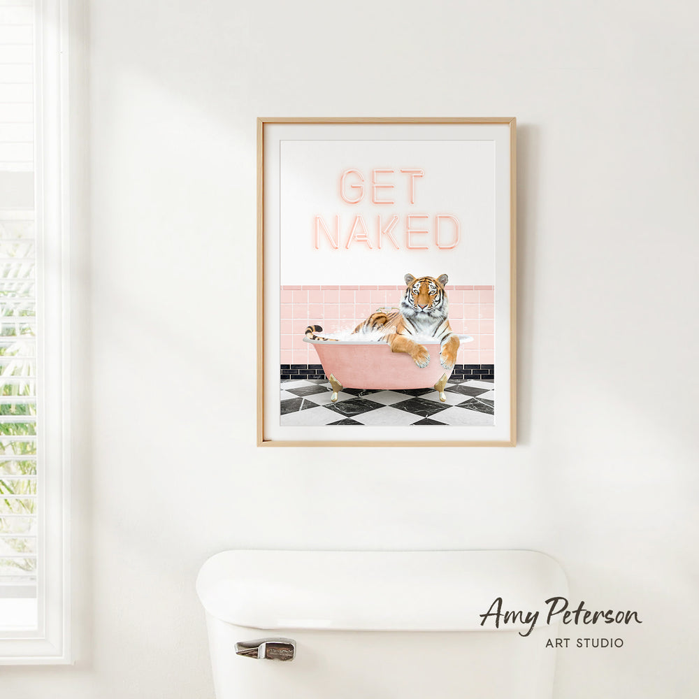 A framed poster with a tiger sitting in a pink bathtub, with the text "GET NAKED" displayed on the poster.