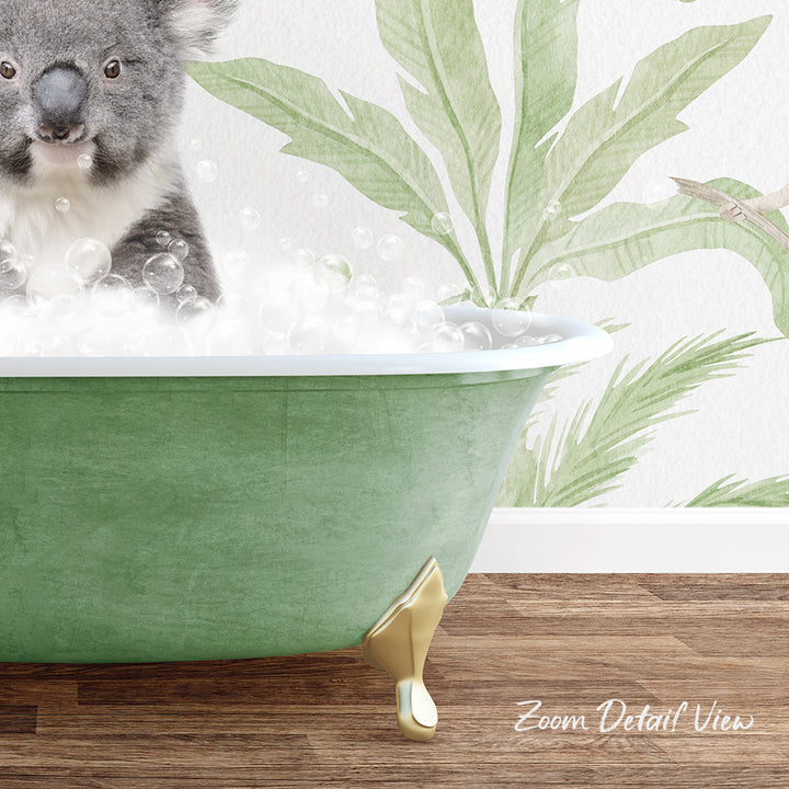 A koala is sitting in a green bathtub filled with bubbles, with a tropical plant mural in the background.