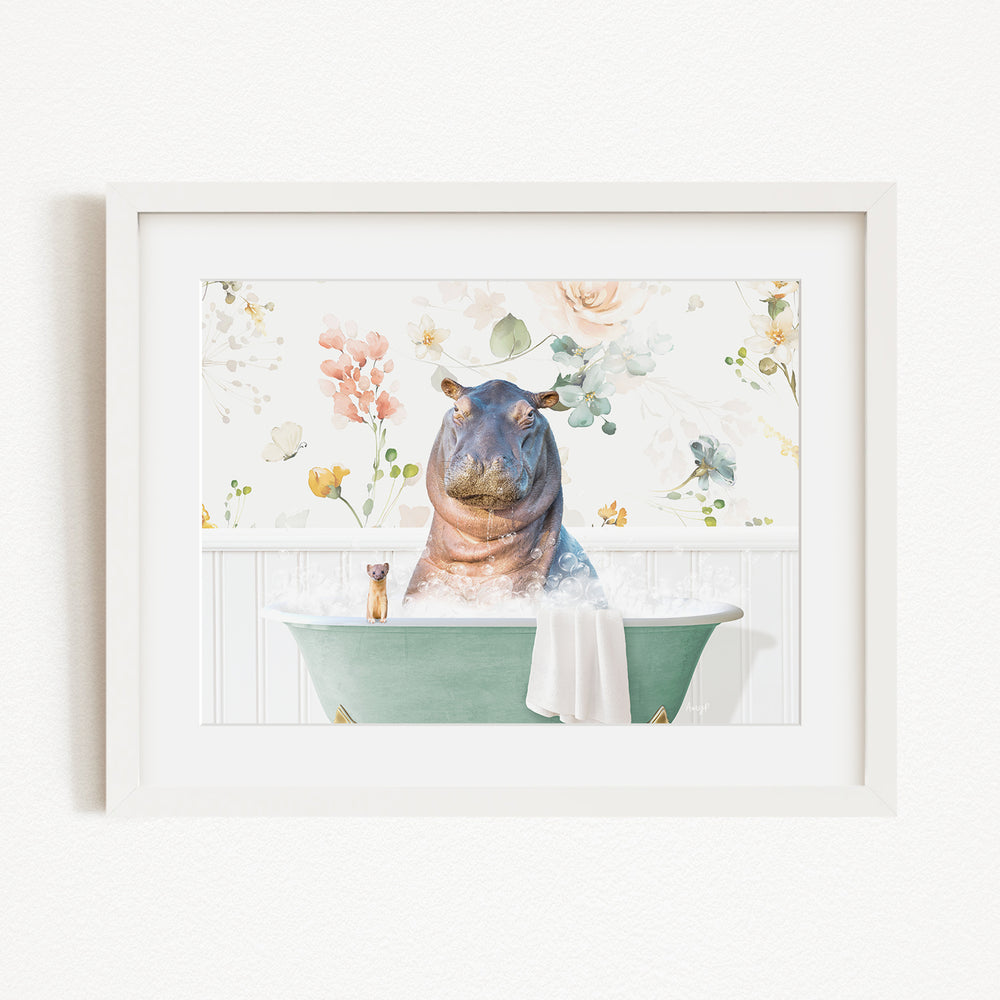 A framed image depicting a hippopotamus sitting in a green bathtub, surrounded by colorful flowers and plants.