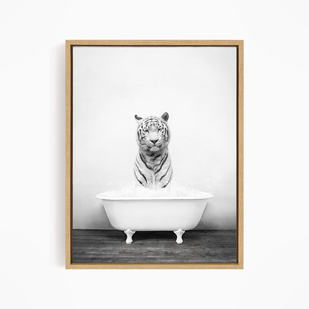 A black and white photograph of a tiger sitting in a bathtub filled with water.