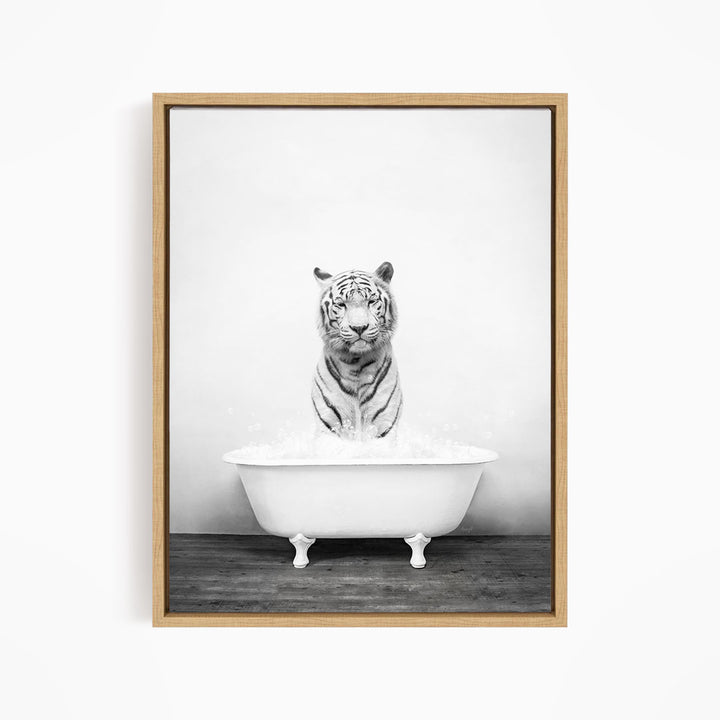 A black and white photograph of a tiger sitting in a bathtub filled with water.