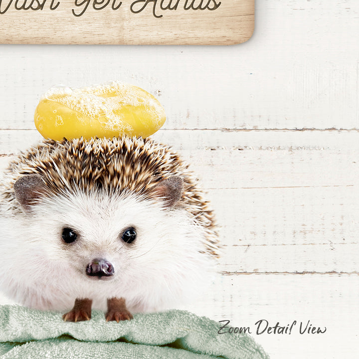 A hedgehog sitting on a towel with a yellow object on top of it.