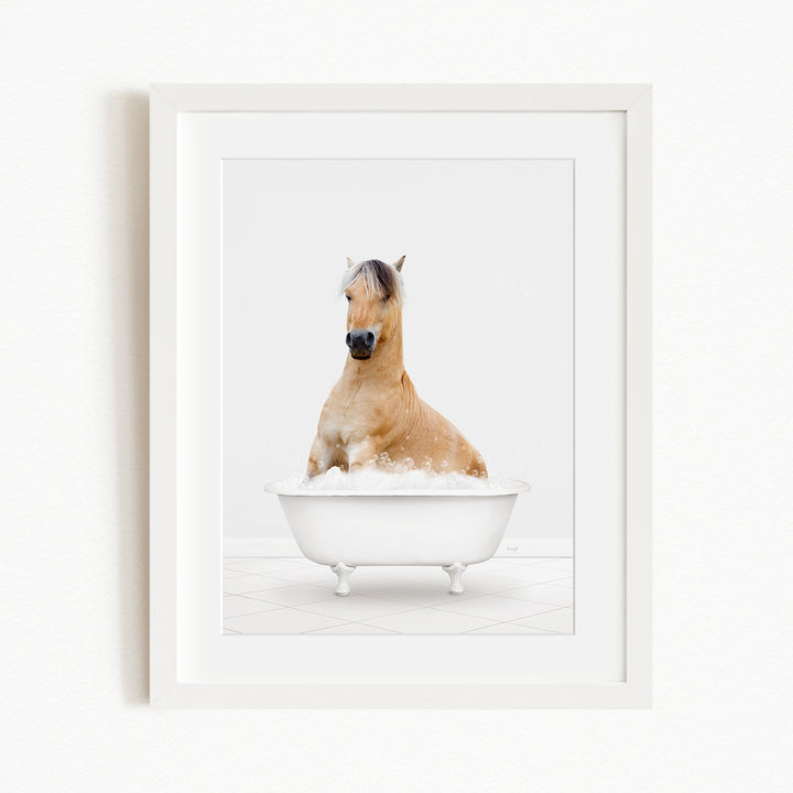 A light brown horse is sitting in a white bathtub filled with water, creating a whimsical and playful scene.