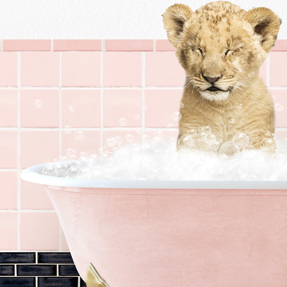 a lion cub sitting in a bathtub filled with bubbles