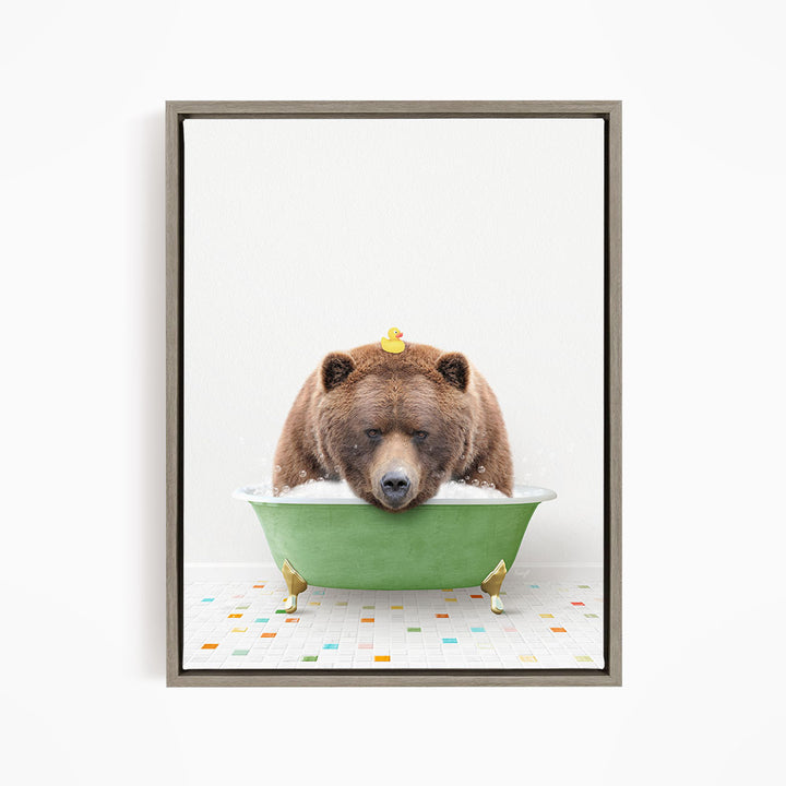 A brown bear is sitting in a green bathtub, with a yellow rubber duck perched on its head.