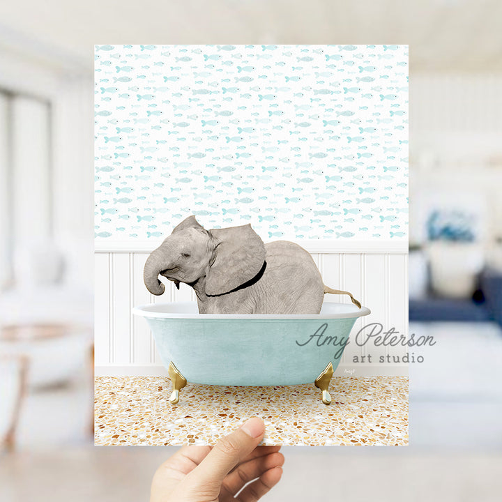 a hand holding up a card with an elephant in a bathtub