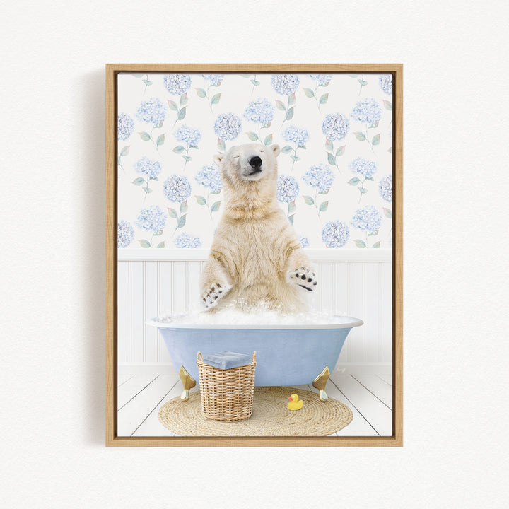 A polar bear is sitting in a blue bathtub filled with water, surrounded by a wicker basket and rubber ducks.