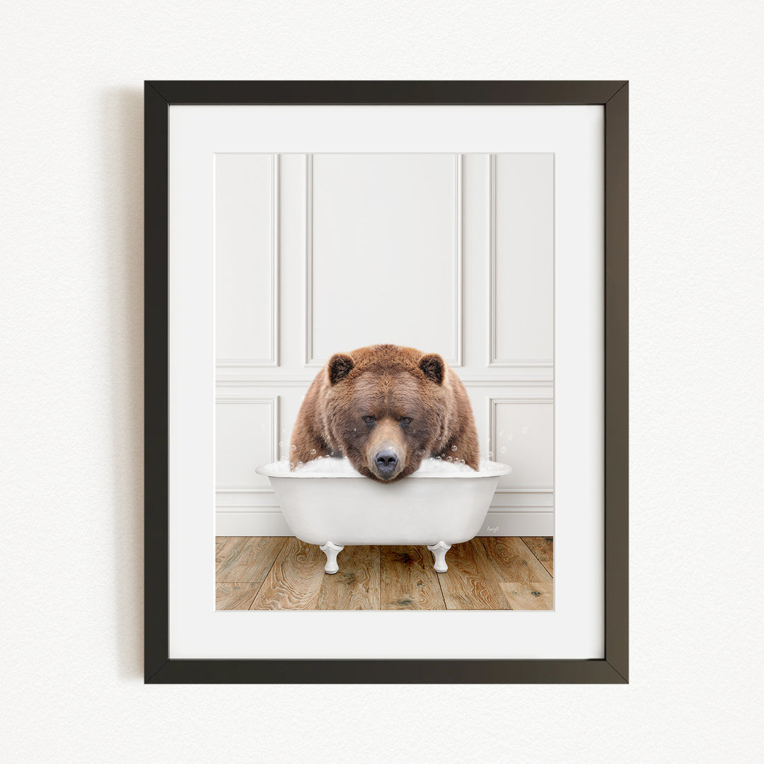 A brown bear is sitting in a white bathtub, appearing to be enjoying a relaxing bath.