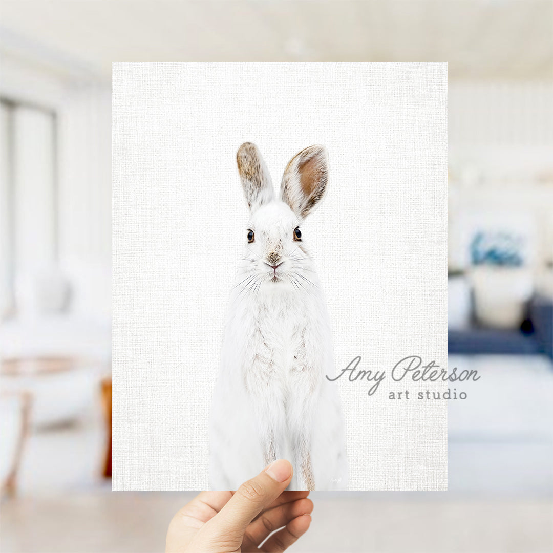 a person holding a card with a picture of a rabbit