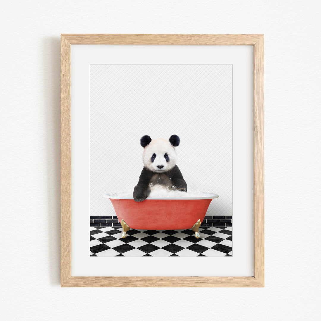 A panda bear sitting in a red bathtub on a black and white checkered floor.
