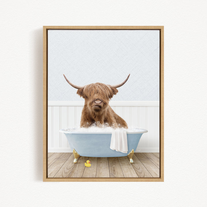 A Highland cow with long horns is sitting in a bathtub filled with water, surrounded by rubber ducks.