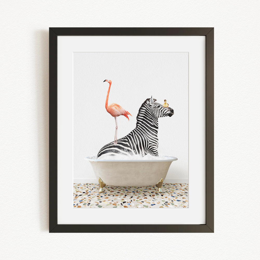 A framed image depicting a zebra sitting in a bathtub with a flamingo standing on its back.