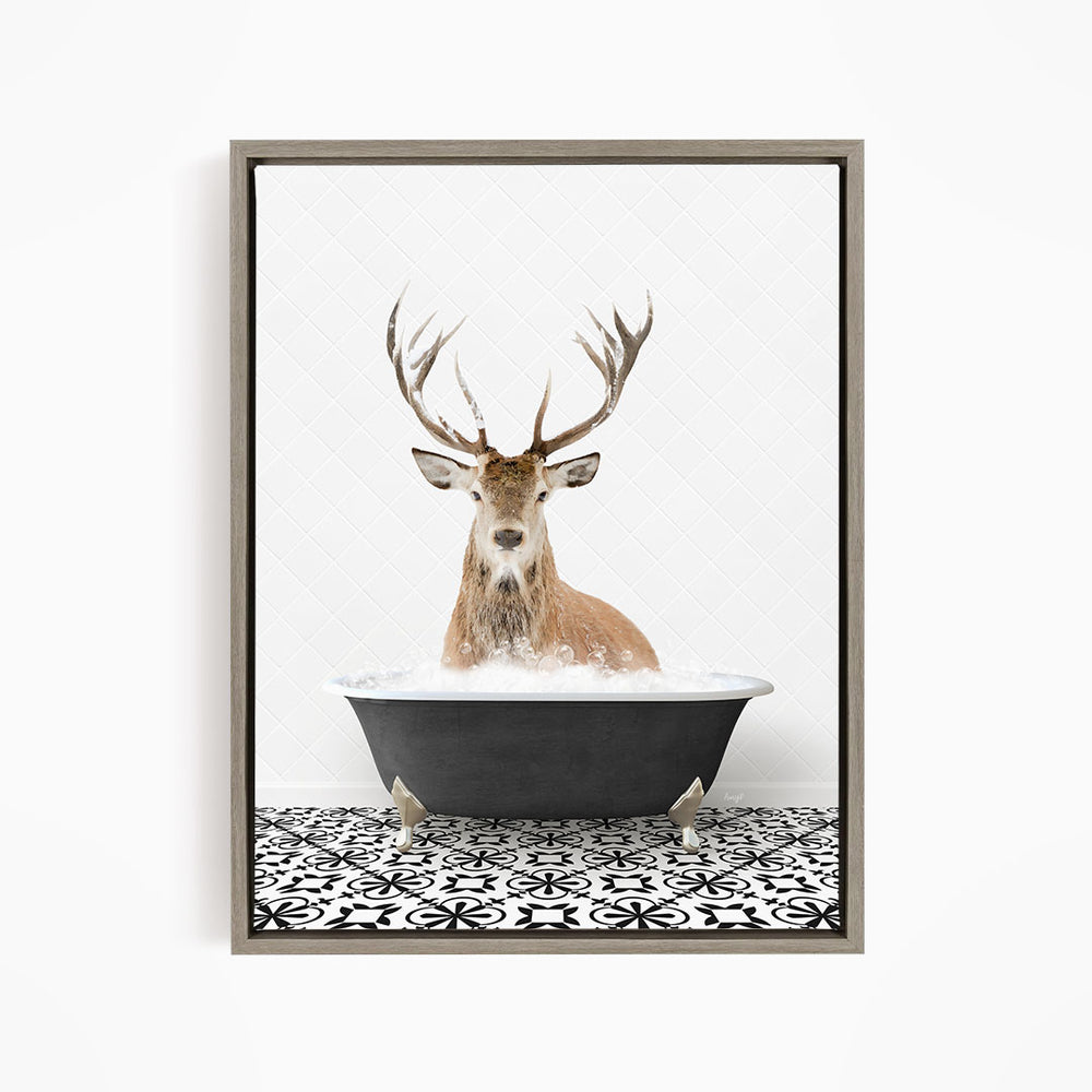 A deer with large antlers is sitting in a bathtub filled with water, creating a whimsical and unexpected scene.