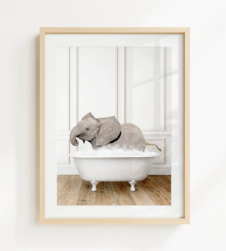 A framed photograph of a baby elephant sitting in a white bathtub filled with water.