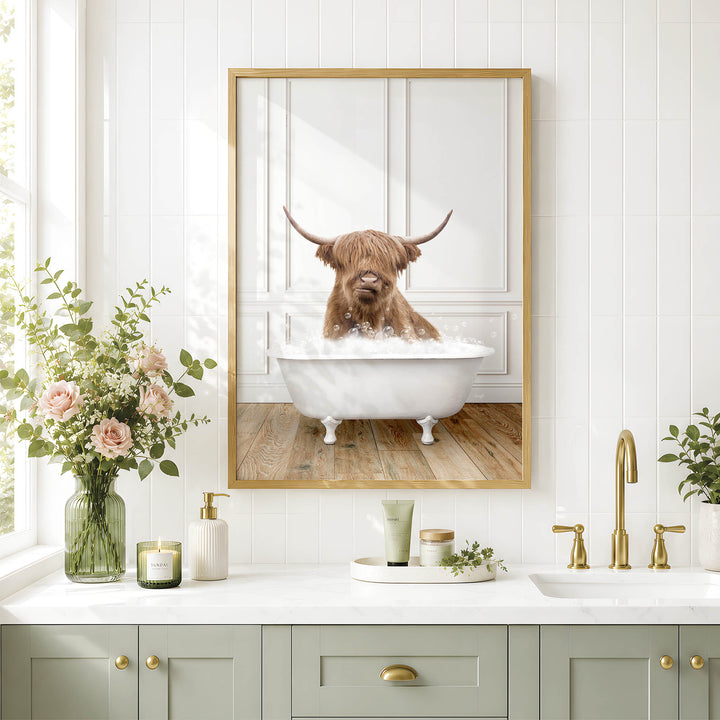 a bathroom with a framed photo of a Highland cow taking a bath in a white bathtub, surrounded by flowers and candles.