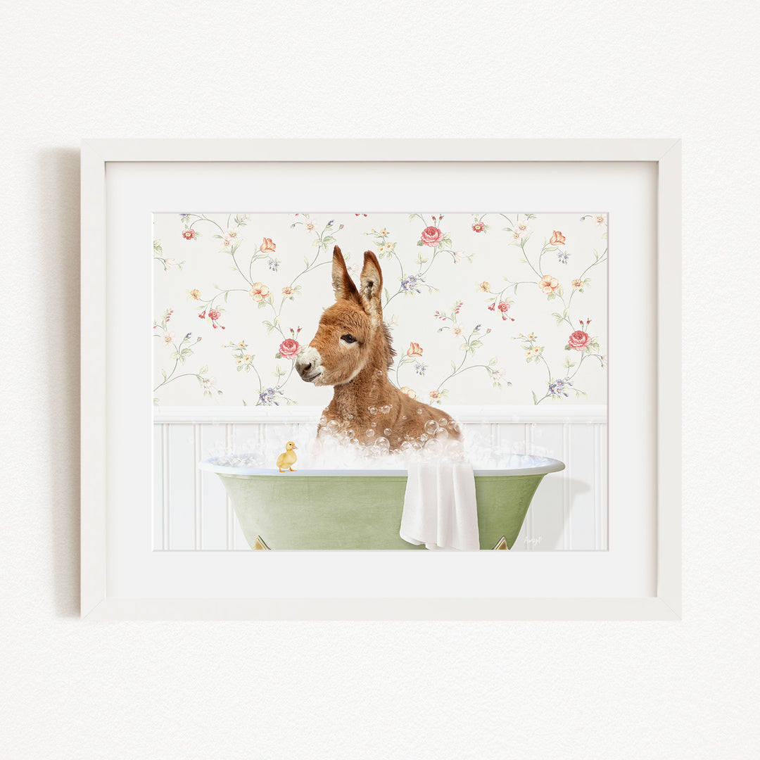 A brown kangaroo is sitting in a green bathtub filled with bubbles, surrounded by a floral patterned wall.