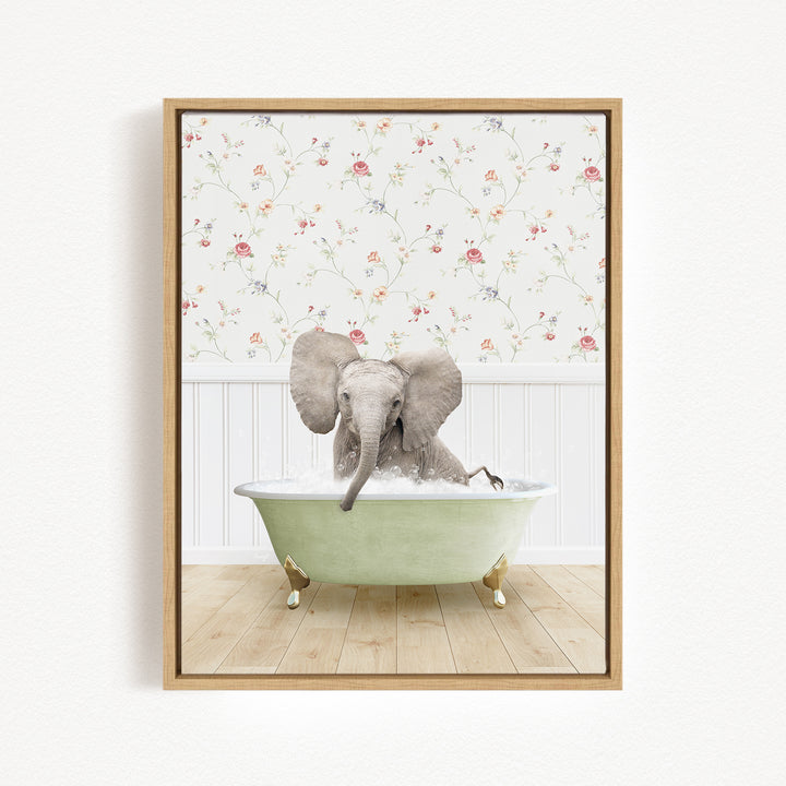 A baby elephant sitting in a green bathtub filled with water, surrounded by a floral wallpaper.