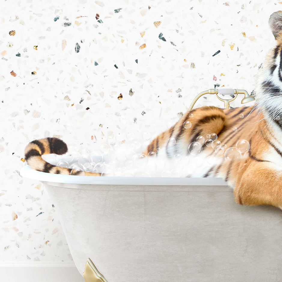 a stuffed tiger sitting in a bath tub