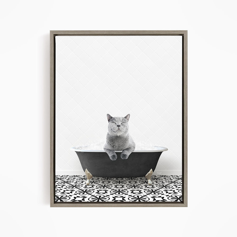 A gray cat sitting in a bathtub filled with bubbles, looking relaxed and content.