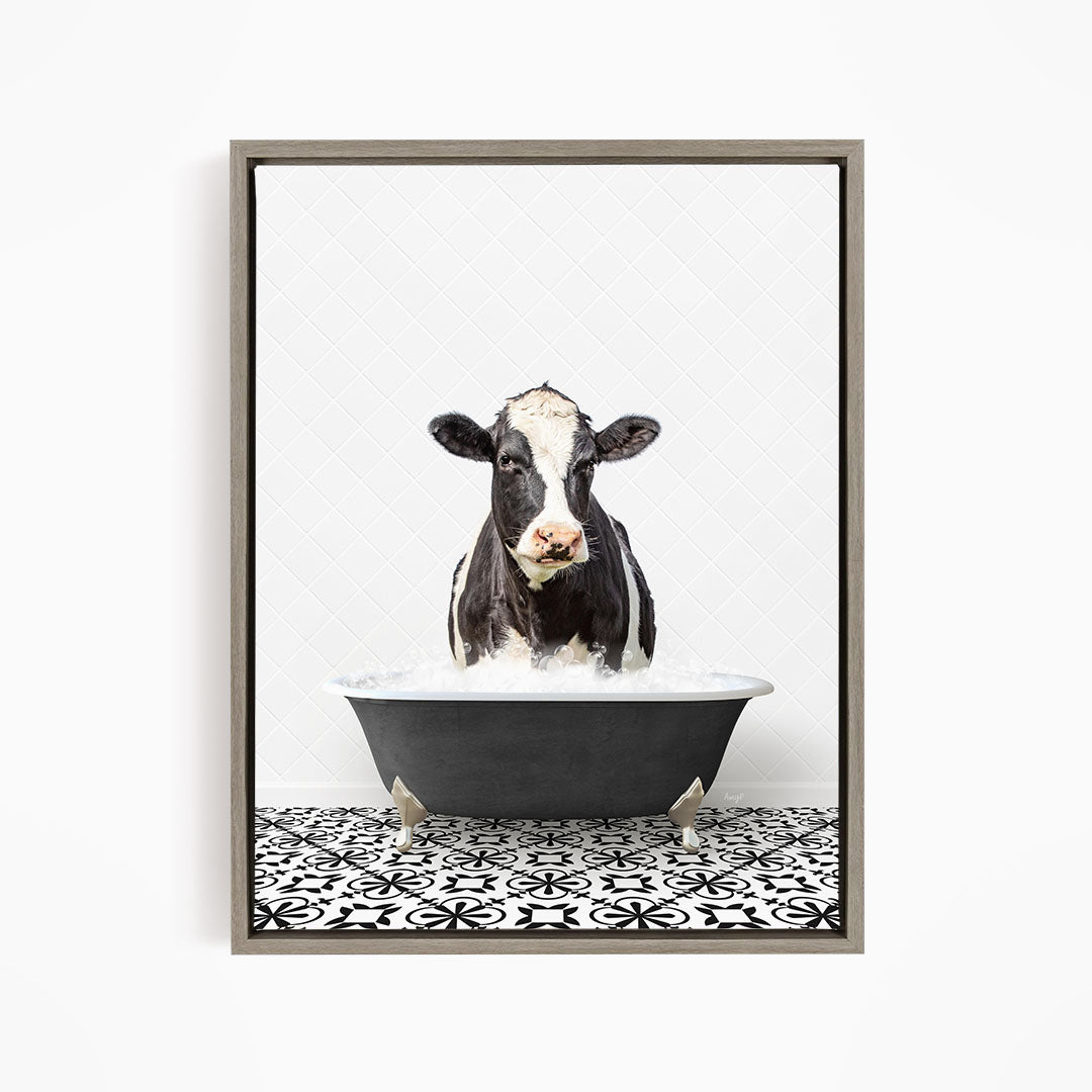 A black and white cow standing in a bathtub filled with water, creating a whimsical and humorous scene.
